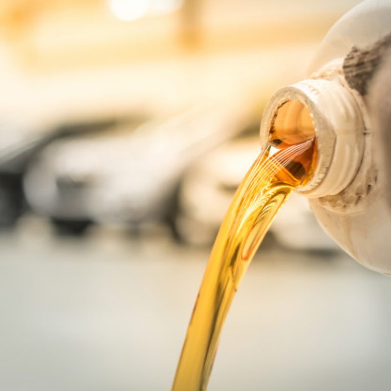 pouring-engine-oil-into-engine-room-gold-oil-during-car-oil-change-repair-shop-service-center-interior-car-care-center_140555-338